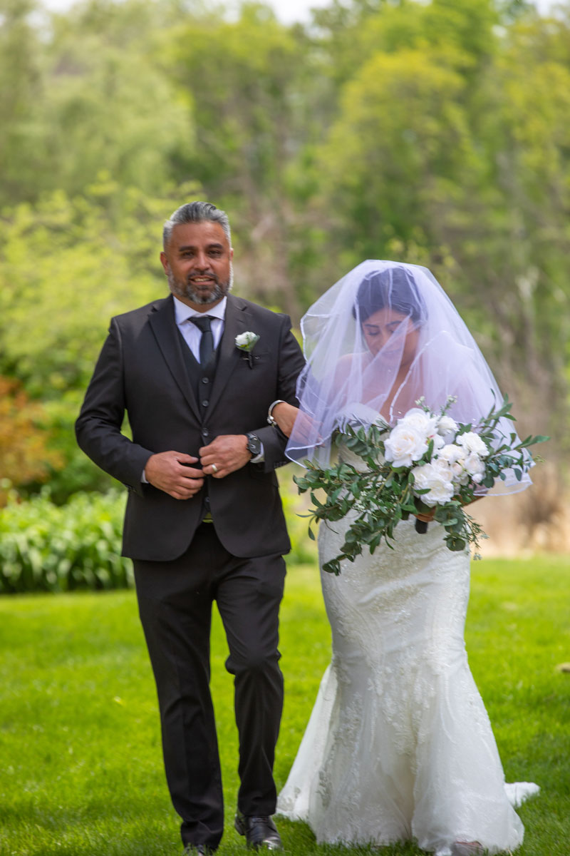 Bride and father walk down the isle, Minnesota outdoor wedding