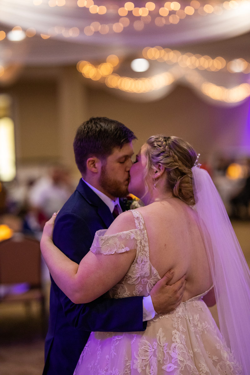 bride and groom kiss during first dance