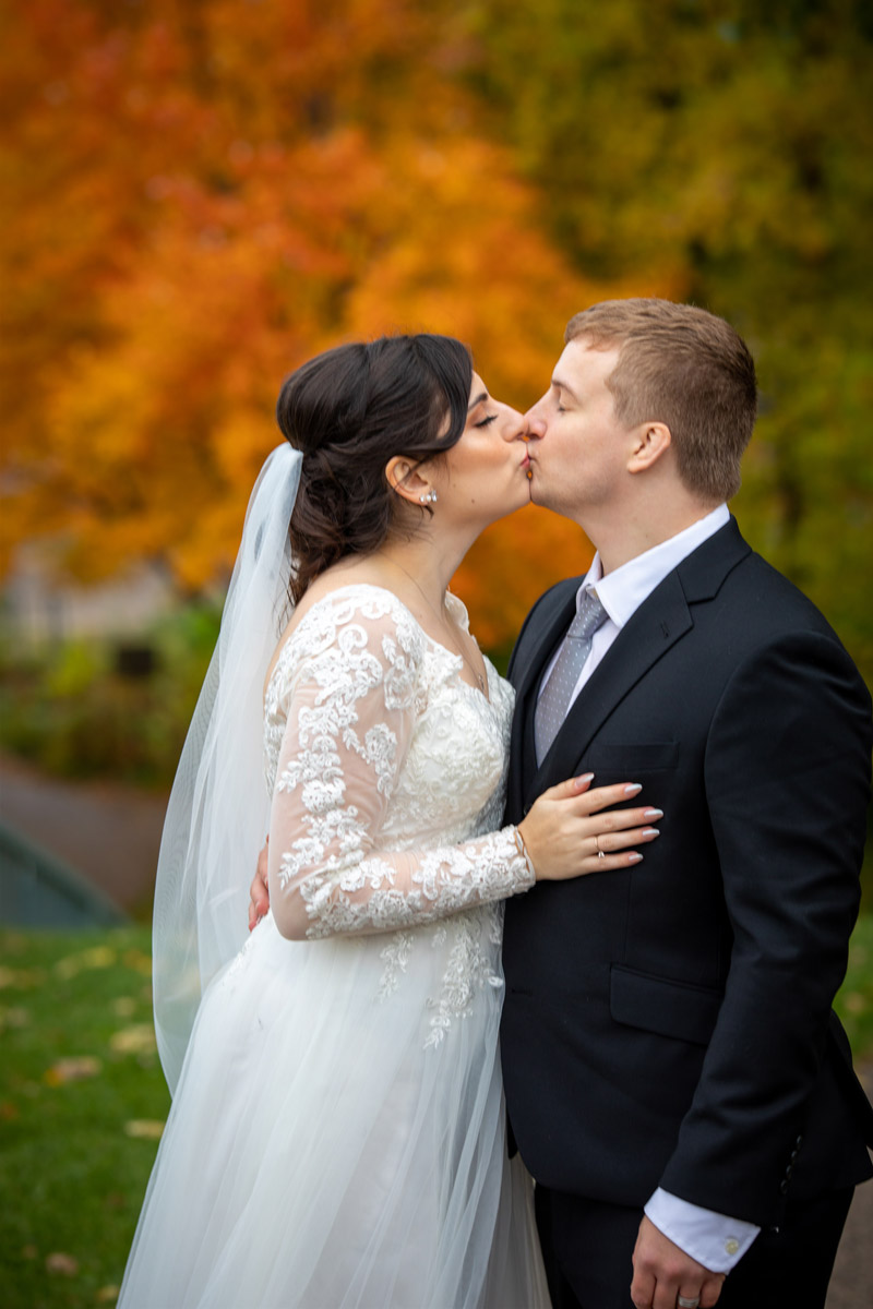 Bride and groom fall wedding kiss