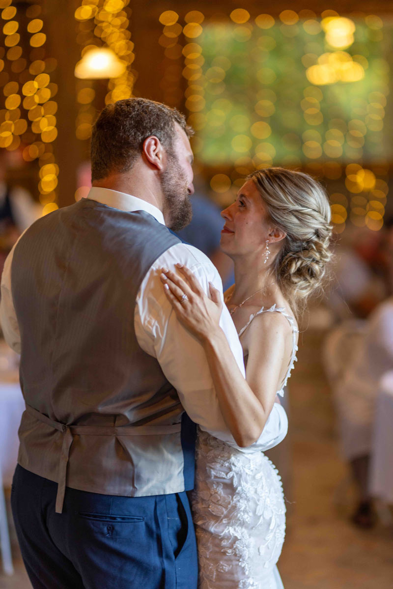 A small smile from a couple on their first dance