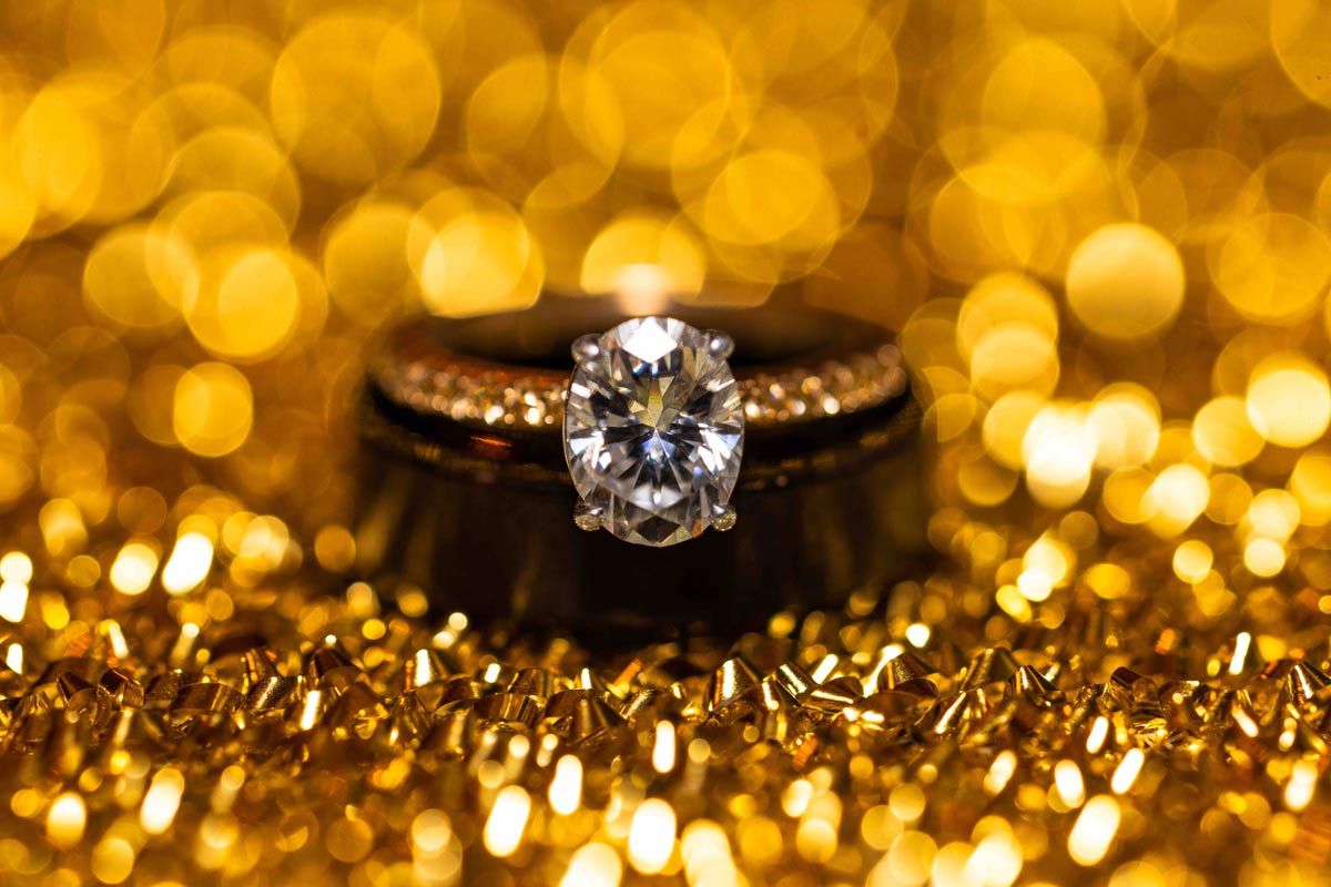 Detailed shot of a wedding ring on a gold background